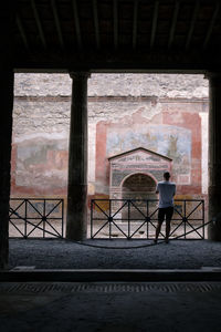 Rear view of man standing in building