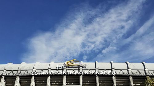 Low angle view of text on building against sky