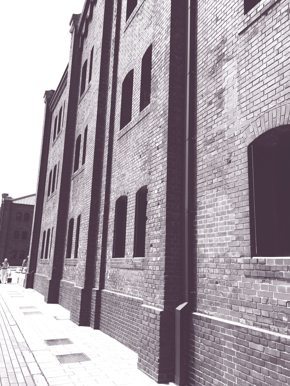 architecture, building exterior, built structure, window, building, brick wall, wall - building feature, low angle view, sunlight, day, outdoors, shadow, facade, pattern, no people, wall, city, exterior, old, history