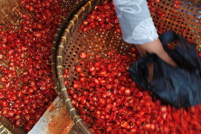 High angle view of woman working on slices of peppers