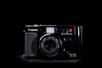 Close-up of camera against black background