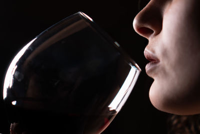 Close-up portrait of a woman drinking glass