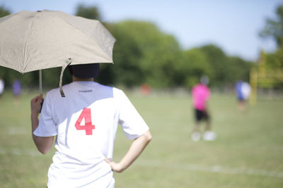 Rear view of man standing on playground