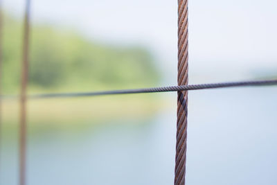 Close-up of rope on wooden fence