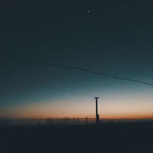 Silhouette landscape against clear sky at sunset
