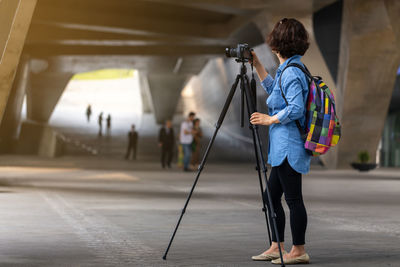 Rear view of woman photographing