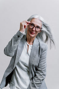 Young woman standing against white background