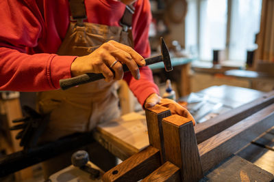 Midsection of man working in workshop