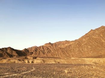 Scenic view of arid landscape against clear sky