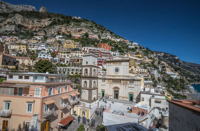 Buildings in town against clear blue sky