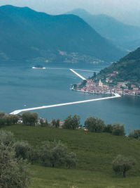 Scenic view of sea and mountains against sky