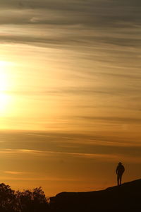 Silhouette of man against sky during sunset