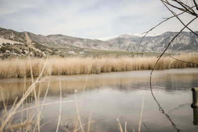 Scenic view of lake and mountains against sky