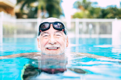 Portrait of senior man swimming in pool