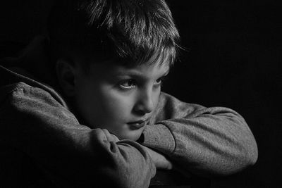 Close-up of thoughtful boy in darkroom