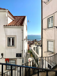 Buildings in city against clear blue sky