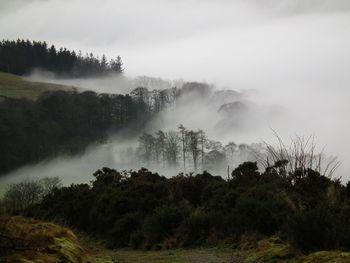 Scenic view of mountains against cloudy sky