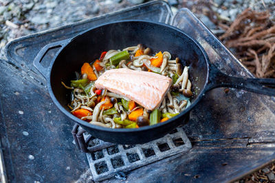 Close-up of food in cooking pan on barbecue grill