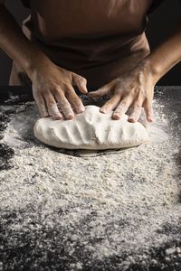 Low section of man preparing food