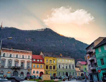 Buildings in town against sky during sunset