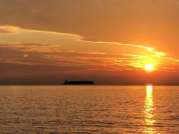 Scenic view of sea against orange sky