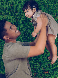 Young father and his adorable baby daughter bonding together enjoying their relationship.