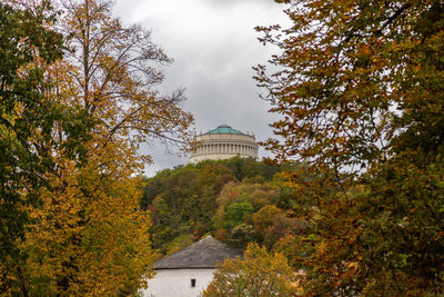 View at the liberation hall  in kelheim, bavaria surrounded by autumnal colorful trees and bushes