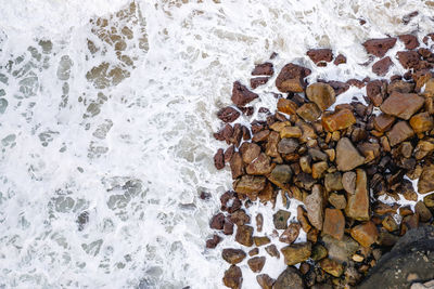 High angle view of rocks by sea