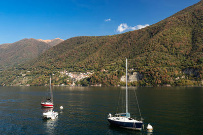 Sailboat sailing on sea against sky