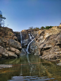 Scenic view of river amidst rocks against clear sky