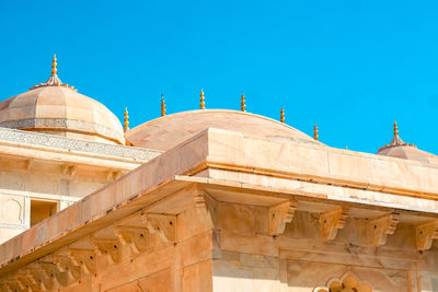 Low angle view of temple building against clear blue sky