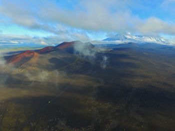 Aerial view of volcanic landscape against sky