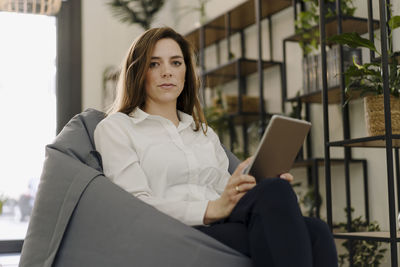 Portrait of young woman using mobile phone