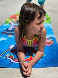 High angle view of girl playing with swimming pool