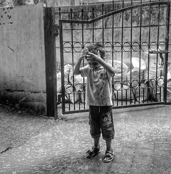 Full length of boy playing with umbrella