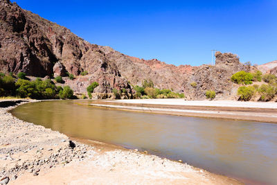 Scenic view of lake against clear blue sky