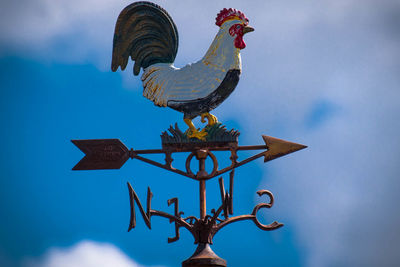 Low angle view of statue against blue sky