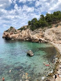 Scenic view of rocks in sea against sky