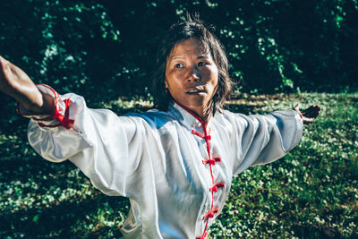 Mature woman practicing martial arts at park