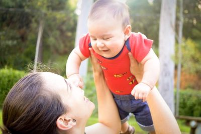 Portrait of woman playing with baby