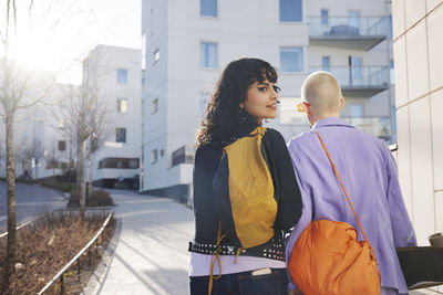 Rear view of female friends or gay couple walking together