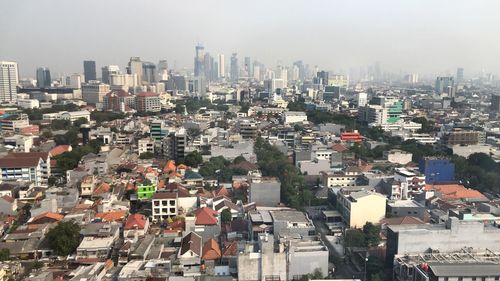 High angle view of buildings in city against sky