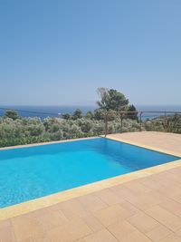 View of swimming pool against clear blue sky