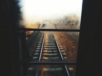 Close-up of railroad track seen through window