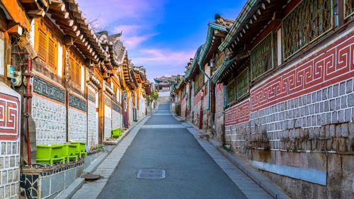 Empty road along buildings