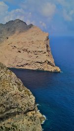 Scenic view of rocks in sea against sky