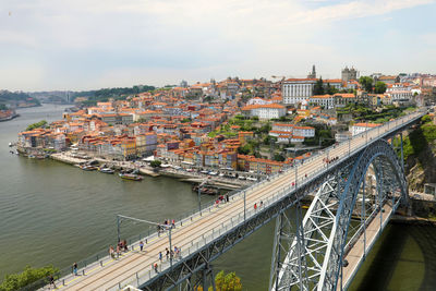 People on dom luis i bridge over douro river in city