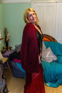 Woman looking away while standing at home