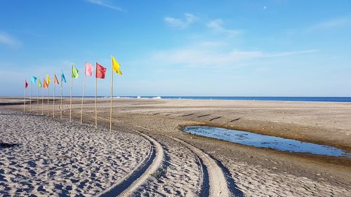 Scenic view of beach against blue sky