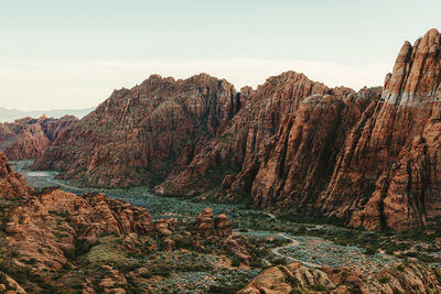 Red cliffs of snow canyon state park with green valley road beneath